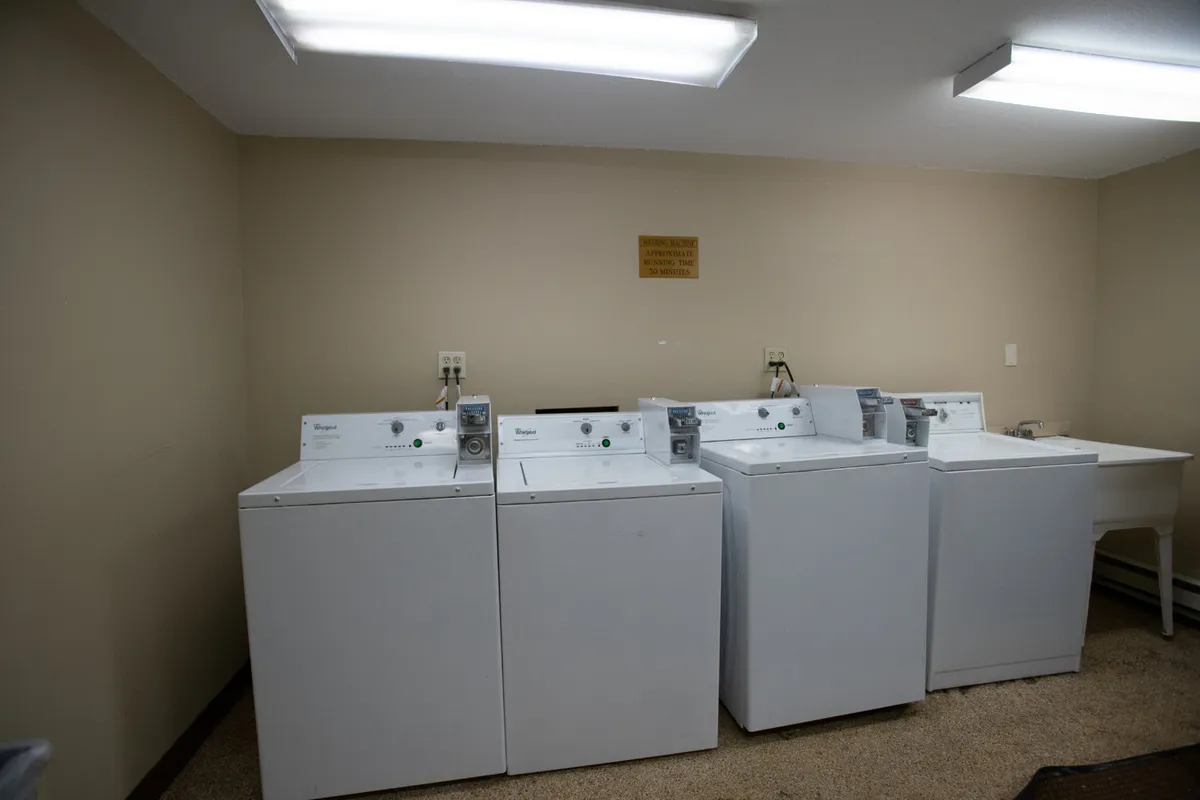 A functional, modern laundry area with washing machines and dryers arranged for guest convenience. The space is clean and practical, highlighting thoughtful amenities for longer stays.